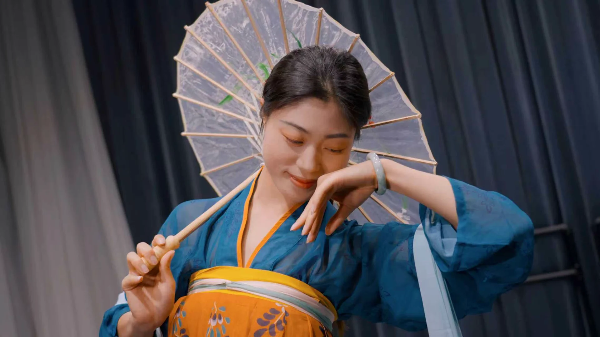A dancer showing costume and creative work in a rehearsal space